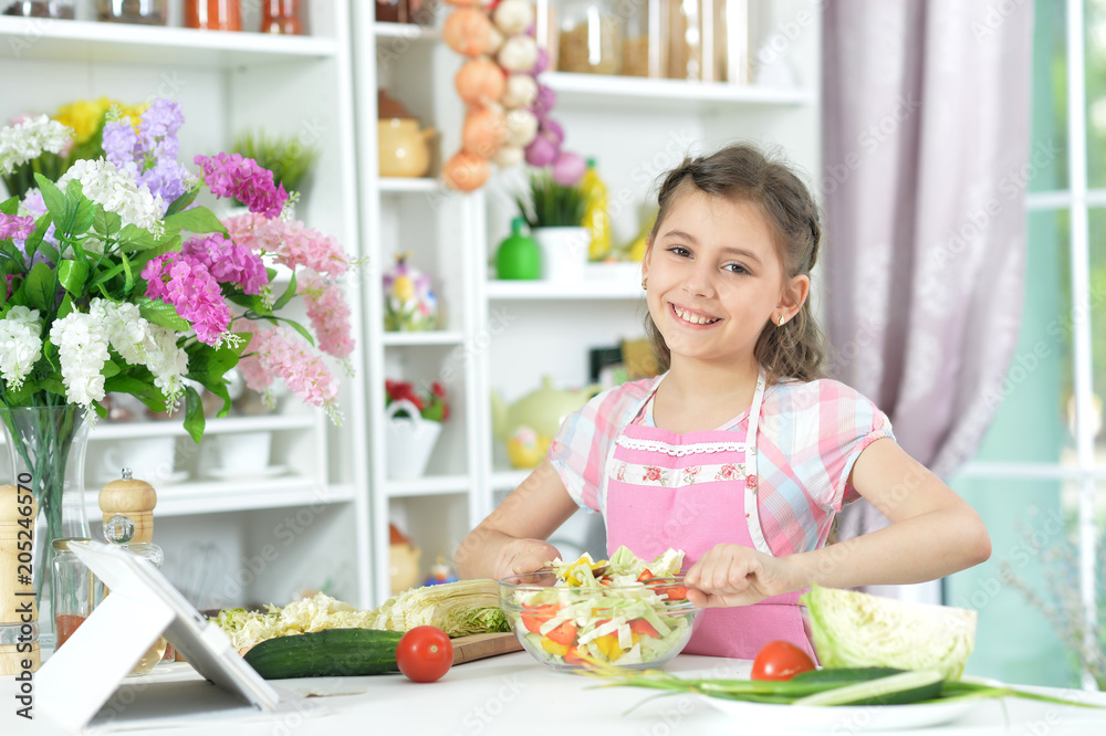 Cute little girl making dinner