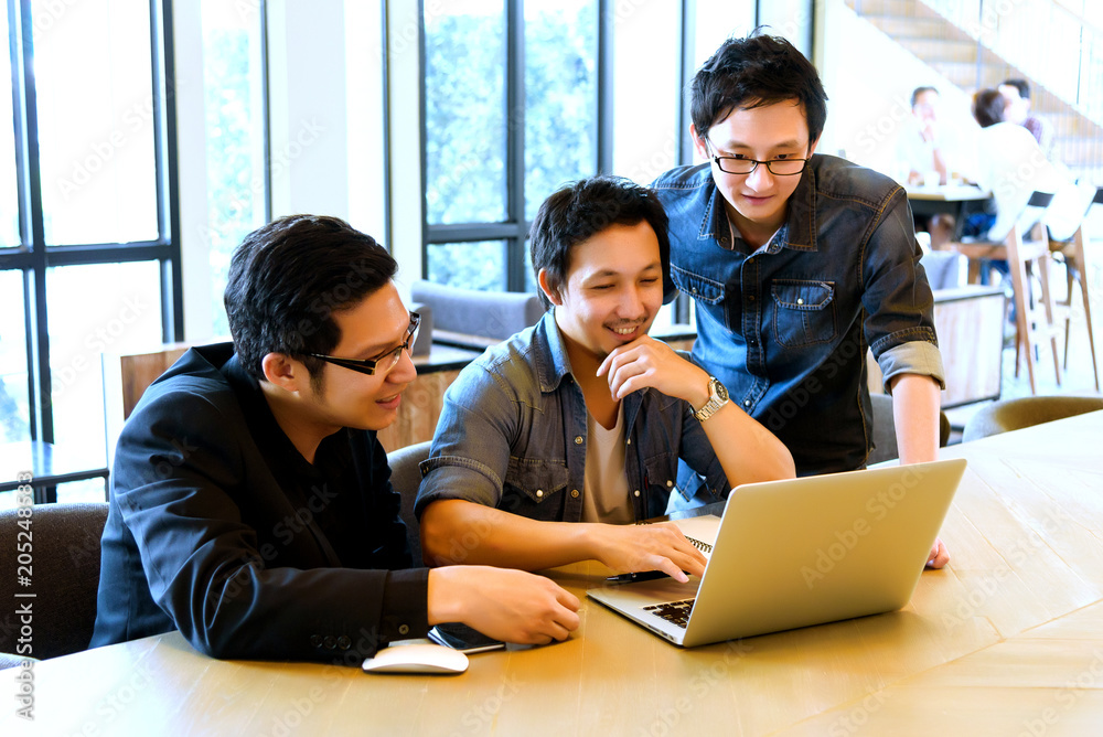 Group of Asian Business man or student in casual suit meeting and looking presentation project on thier laptop in the modern office or coffee shop, Project and Business concept Group of Asian Business man or student in casual suit meeting and looking presentation project on thier laptop in the modern office or coffee shop, Project and Business concept