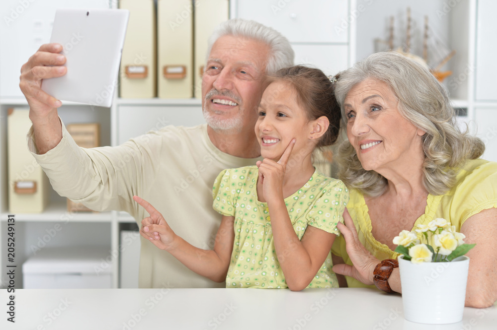 Grandparents with her granddaughter taking selfie Grandparents with her granddaughter taking selfie