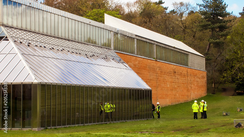 Reflection of  architects and surveyors in the windows of the building housing The Burrell Collection during its renovation.  photo