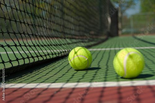 Brightly colored felt Green, Yellow Tennis balls on tennis court © jaflippo