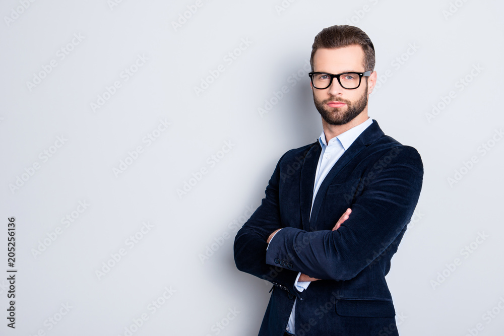 Portrait with copy space, empty place for advertisement of elegant half turned teacher with stubble having his arms crossed looking at camera isolated on grey background Portrait with copy space, empty place for advertisement of elegant half turned teacher with stubble having his arms crossed looking at camera isolated on grey background