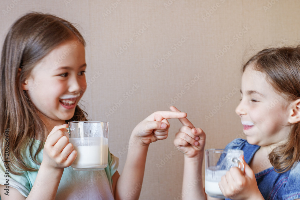 two funny little girls with white mustache from milk two funny little girls with white mustache from milk