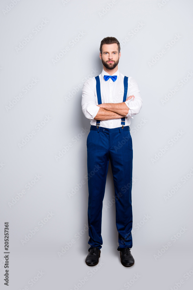 Full size full body portrait of famous talented singer in blue ourfit, wearing bow, white shirt, suspenders, isolated over grey background, holding arms crossed Full size full body portrait of famous talented singer in blue ourfit, wearing bow, white shirt, suspenders, isolated over grey background, holding arms crossed