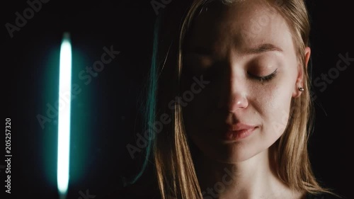A woman is crying in the dark. She is very sad. Tears flow down her cheeks. 4k