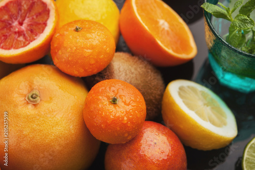 Heap of citruses on black background, closeup