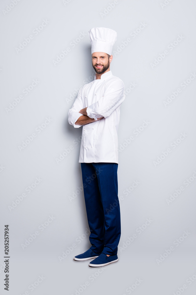 Full size body portrait of joyful positive chef cook with stubble in beret, having his arms crossed, isolated over grey background, looking at camera Full size body portrait of joyful positive chef cook with stubble in beret, having his arms crossed, isolated over grey background, looking at camera