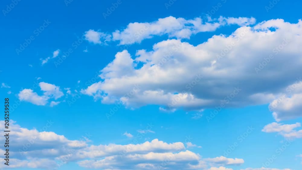 Blue sky and fast white cumulus clouds - time lapse