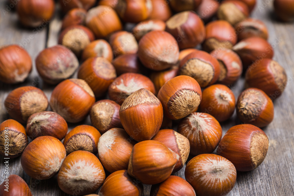 Hazelnuts in shell on the rustic background. Selective focus. Hazelnuts in shell on the rustic background. Selective focus.