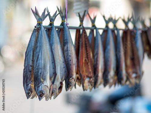 a row of hang fish in fresh market