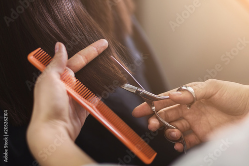 Cropped shot of female client receiving a haircut