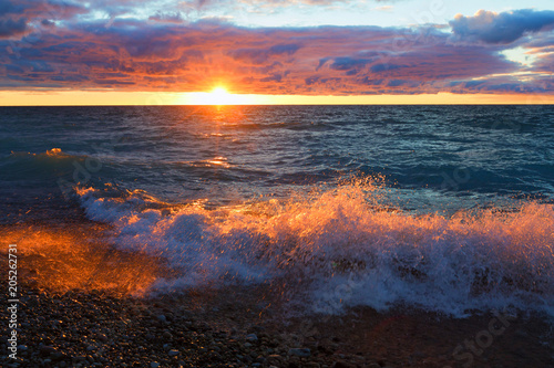 Sunset and Wave Splash on Lake Michigan. Sleeping Bear Dunes, Michigan, USA