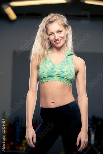 portrait of a beautiful young athlete in a gym closeup