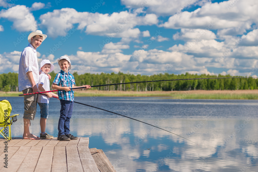 The boys and their father spend a day on a fishing trip on a sunny day The boys and their father spend a day on a fishing trip on a sunny day