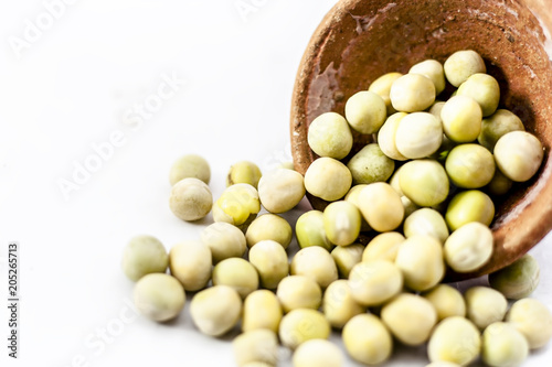 Dried fresh green pea in a clay bowl ioslated on white.; photo