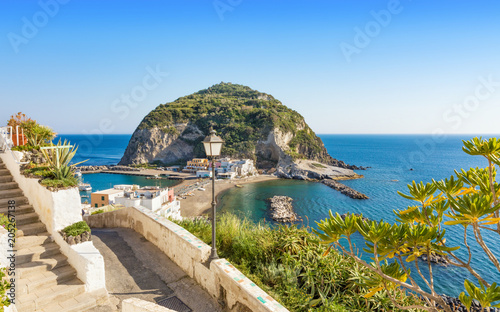 Giant rock with green trees on top near small village Sant'Angelo on Ischia island, region Campania in Italy 