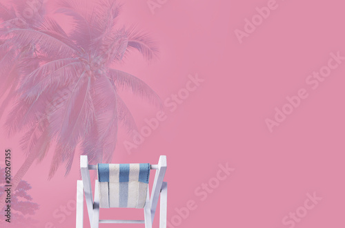 Minimal summer concept of beach chair on pink background