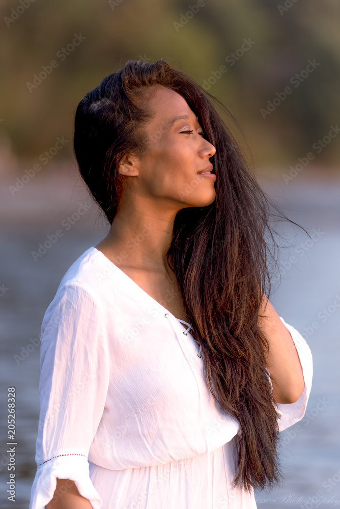 Beautiful Asian model from Tibet posing at sunset for portrait photography Beautiful Asian model from Tibet posing at sunset for portrait photography