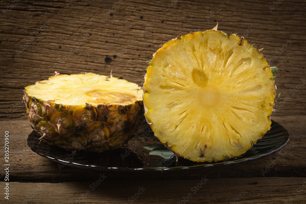 pineapple on dish half on old wood pineapple on dish half on old wood