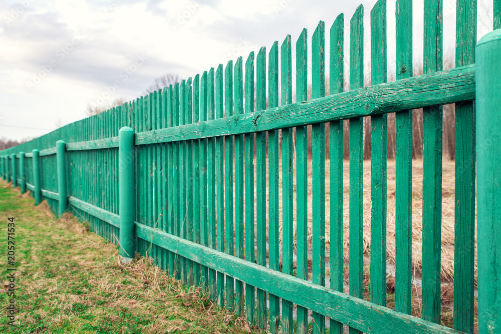 Rustic green wooden fence in countryside Rustic green wooden fence in countryside
