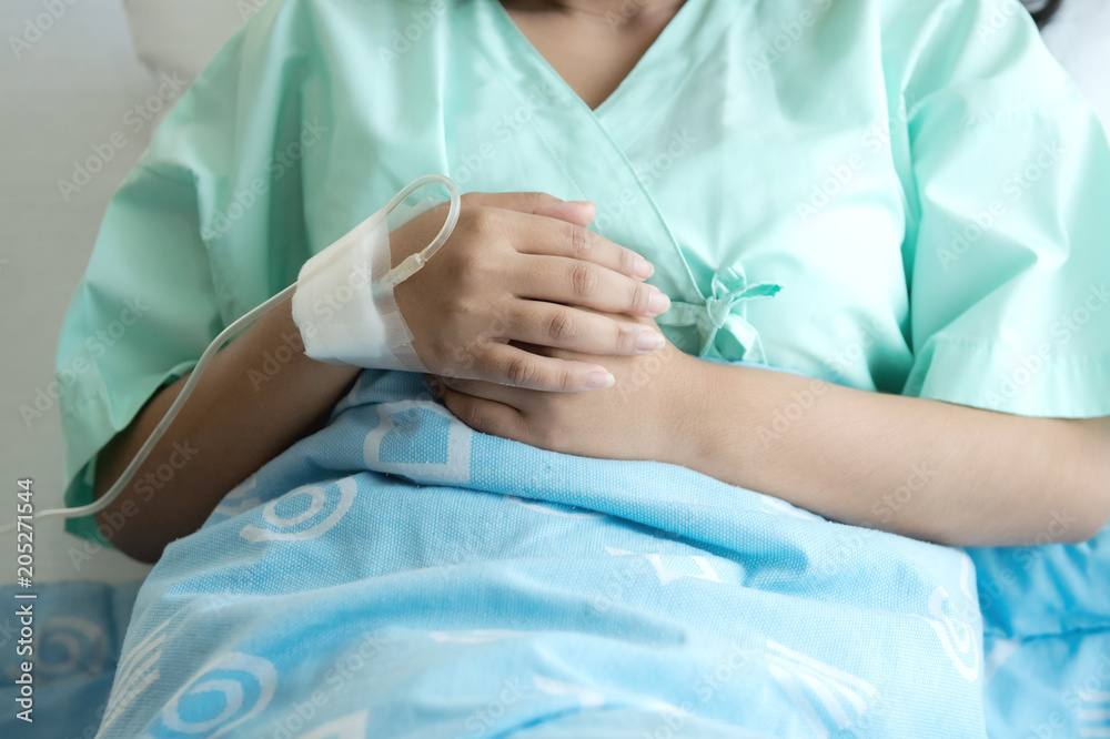 Young patient alone in bed. Sleeping in hospital bed. Body shot. Young beautiful chinese woman. Young patient alone in bed. Sleeping in hospital bed. Body shot. Young beautiful chinese woman.