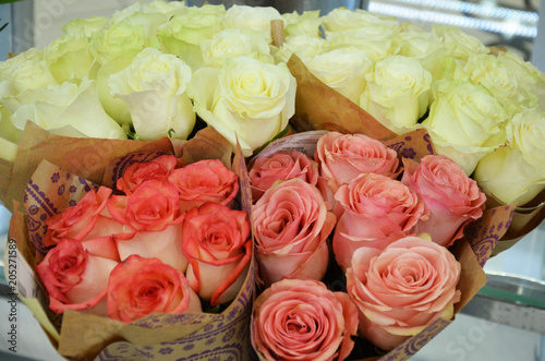 Beautiful bouquets of roses are presented in street flower shop