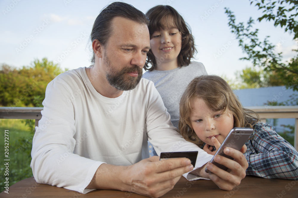family shopping online via the terrace on a summer evening family shopping online via the terrace on a summer evening