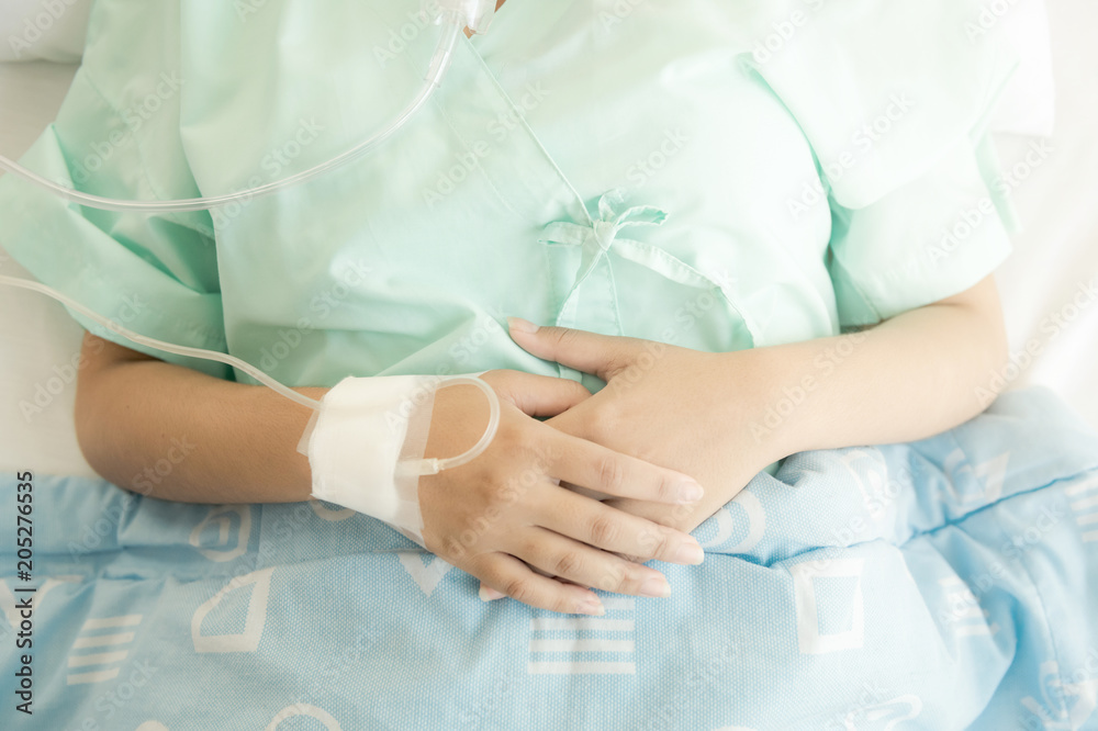 Young patient alone in bed. Sleeping in hospital bed. Body shot. Young beautiful chinese woman.