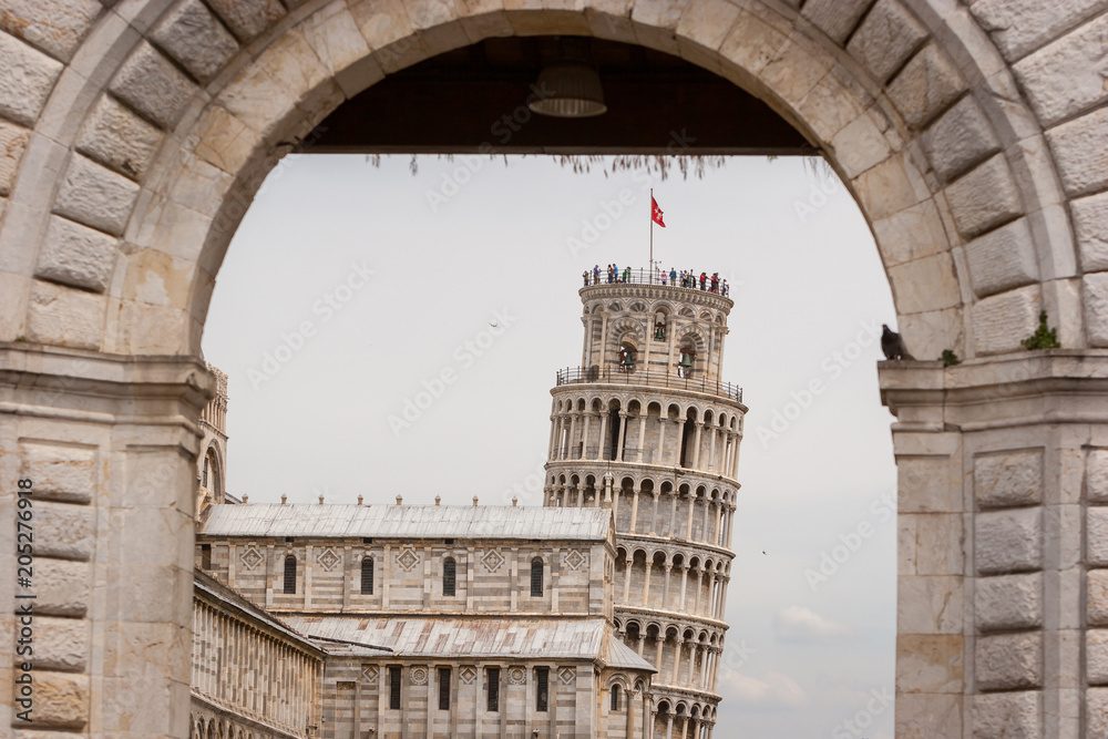 View thru the Porta Santa Maria of Pisa Cathedral, Roman Catholic cathedral dedicated to the Assumption of the Virgin Mary and the Leaning Tower of Pisa, bell tower of cathedral in Pisa, Italy.