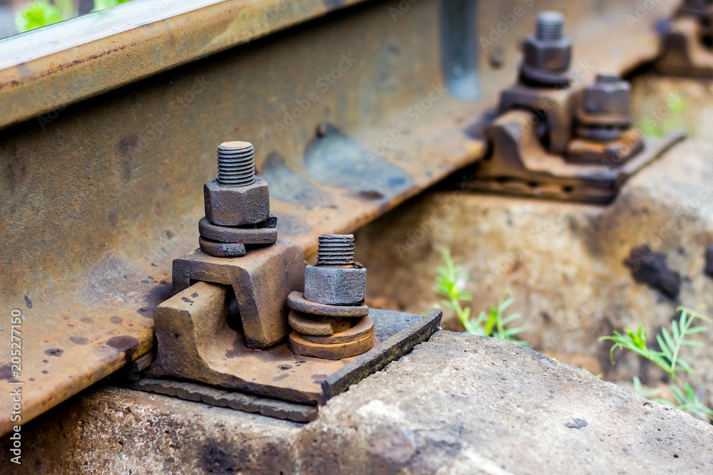Old rust bolts for mounting rails on railroad track. Bolt connection of parts_ Old rust bolts for mounting rails on railroad track. Bolt connection of parts_