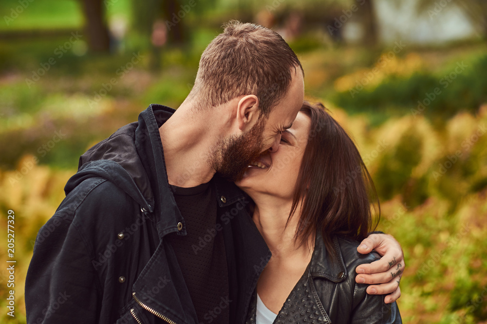Happy modern couple in a park. Enjoying their love and nature. Happy modern couple in a park. Enjoying their love and nature.