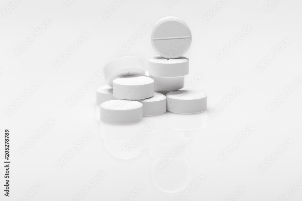 white pills on blue background white pills on blue background
