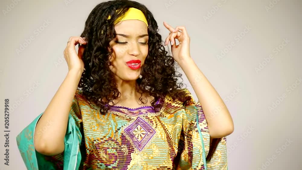 Close up shot of a lovely and beautiful brunette woman singing and enjoying day in studio. Close up shot of a lovely and beautiful brunette woman singing and enjoying day in studio.
