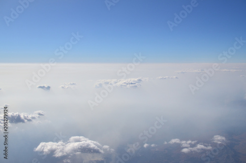 Cloudscape seen from an airplane during flight above the clouds