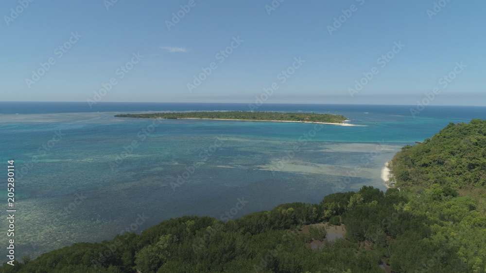 Tropical island with white sandy beach. Aerial view: Magalawa island with colorful reef. Seascape, ocean and beautiful beach paradise. Philippines,Luzon. Travel concept. Tropical island with white sandy beach. Aerial view: Magalawa island with colorful reef. Seascape, ocean and beautiful beach paradise. Philippines,Luzon. Travel concept.
