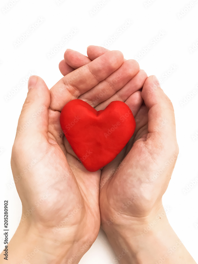 Red heart in hands on a white background Red heart in hands on a white background