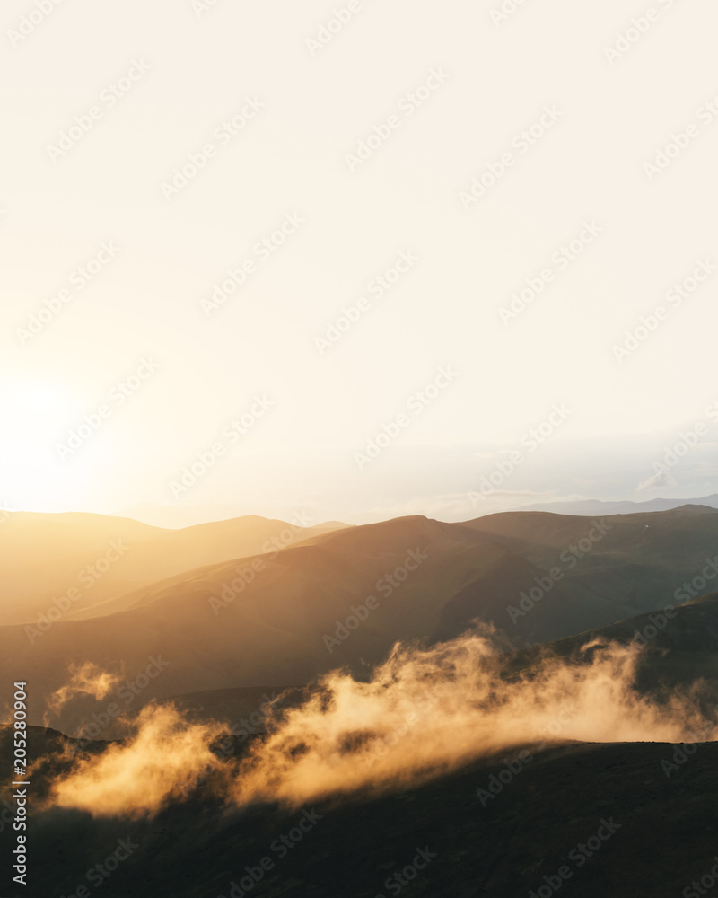 Picturesque summer landscape with colorful sunrise on Carpathian mountains. Mountain ranges in morning light. Travel background concept