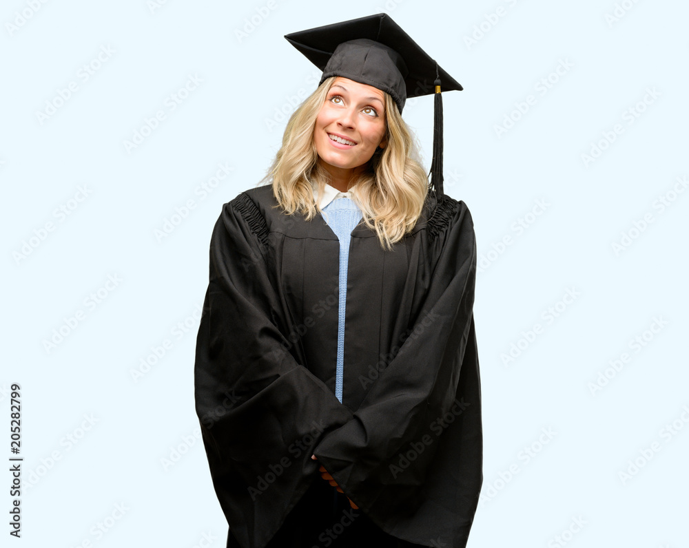 Young graduate woman thinking and looking up expressing doubt and wonder Young graduate woman thinking and looking up expressing doubt and wonder