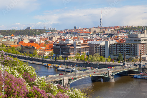 PRAGUE, CZECH REPUBLIC - APRIL, 30, 2017: Spring city panoramic view from Letenske garedn. Old and modern buildings and bridges over Vltava river.