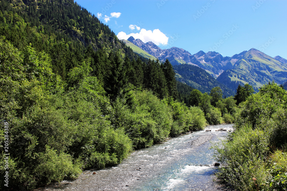 Alpejska rzeka i góry w tle