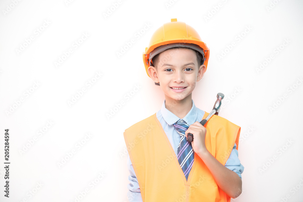 Young boy engineer isolated in white. Handsome early teenage boy portrait with engineering cloth. Holding a hammer. Young boy engineer isolated in white. Handsome early teenage boy portrait with engineering cloth. Holding a hammer.