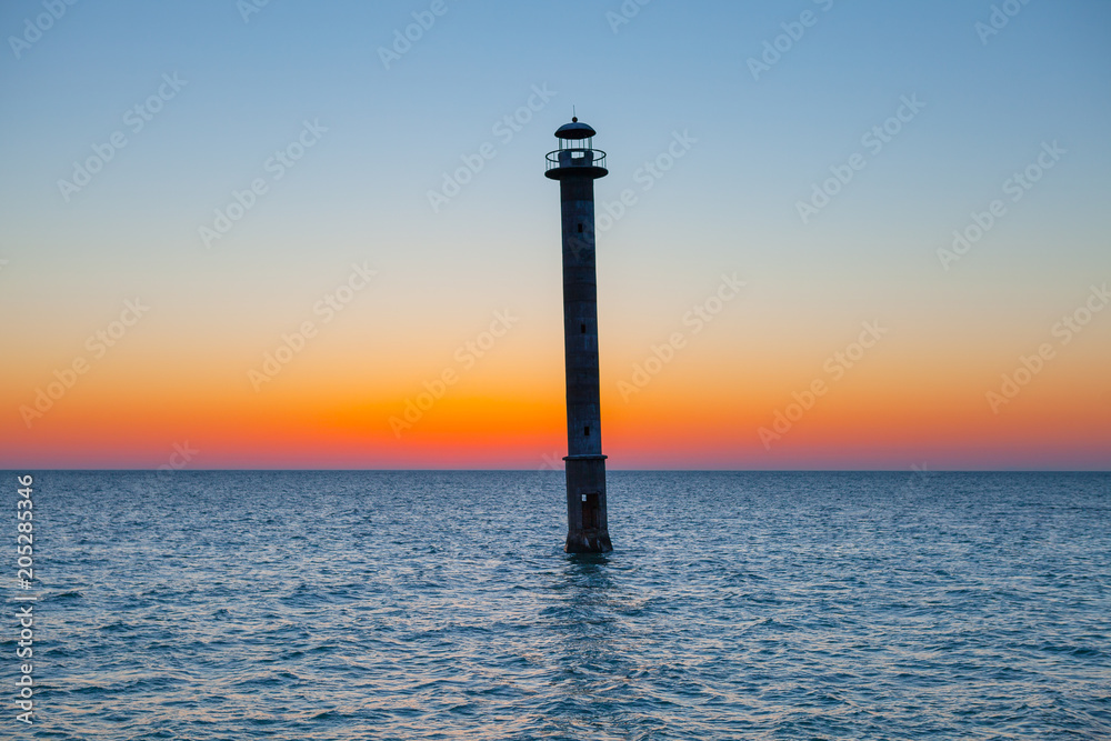 Fototapeta premium Iconic falling Kiipsaare lighthouse at sunset light, island of Saaremaa, Estonia.