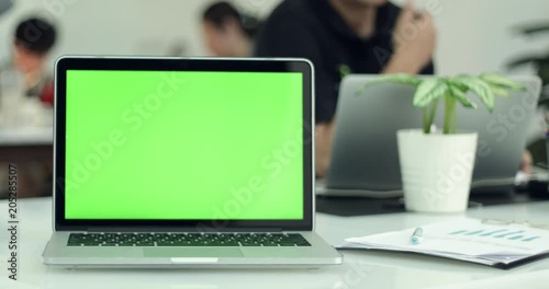 Green laptop computer screen set in front of workgroup