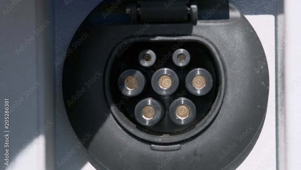 Charging devices for electric cars at exhibition of electric cars. refueling an electric car in the parking lot. Charging devices for electric cars at exhibition of electric cars. refueling an electric car in the parking lot.