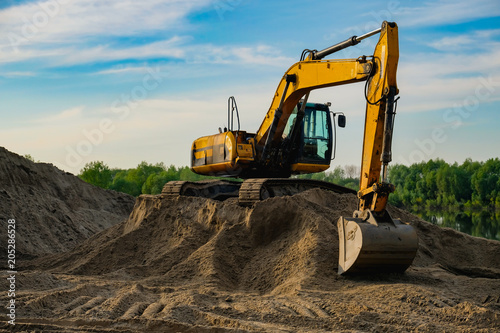 excavator is standing on the sand