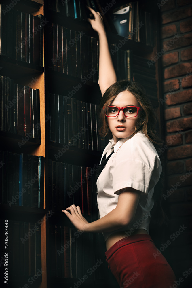 Fototapeta premium schoolgirl in old library