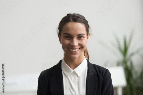 Portrait of happy businesswoman in formal wear smiling to camera in office workplace, posing for company catalogue, business photoshoot. Concept of leadership, confidence
