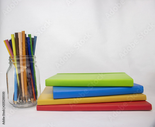 An artist's sketchbooks and pencils on an isolated white background with room for text and more