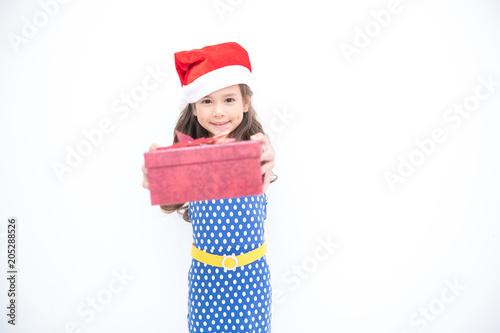 Young girl give suprise gift. Young cute white girl giving a gift present box, looking cute. Isolated in white. Birthday and family concept.