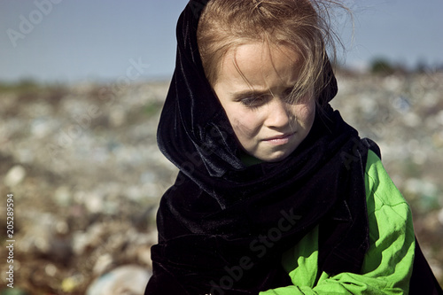 Suffering a beggar child on landfill